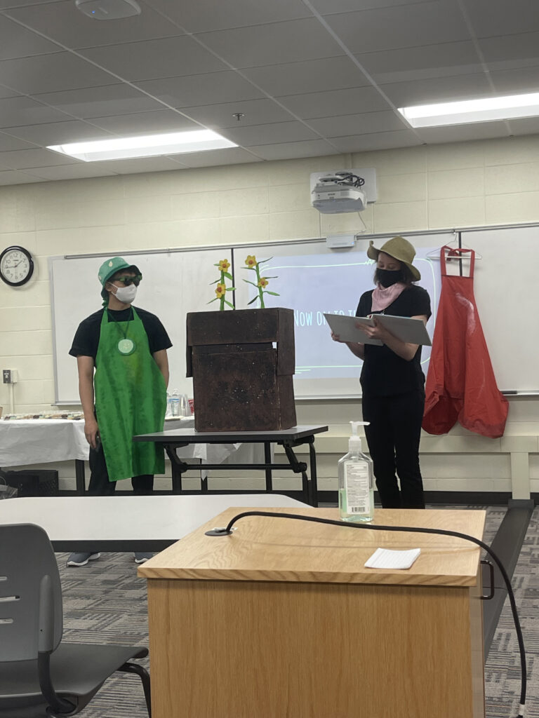 Two women in costume presenting